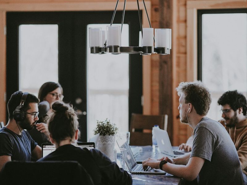 A team gathered around a table in a bright office, planning a project